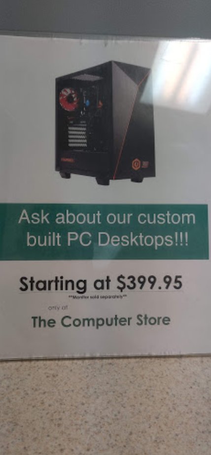 a sign saying "Ask about our custom built PC Desktops!!! starting at $399.95 only at the computer store" and a picture of a desktop computer