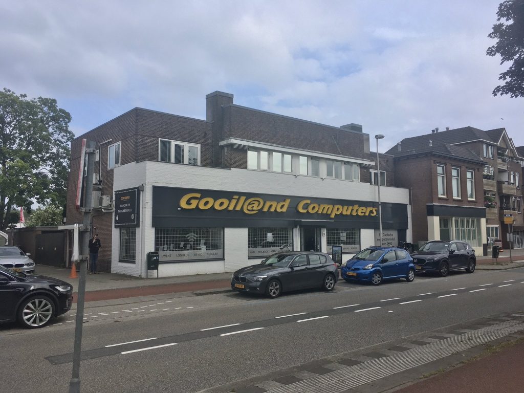 photo from across the street of a white building that says "Gooil@nd Computers"