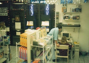 girl and dad sitting at a computer in a store