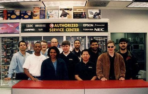 people lined up behind a counter