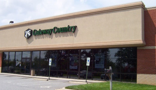 the front of a gateway country store that says the store name and has a box with a cow pattern