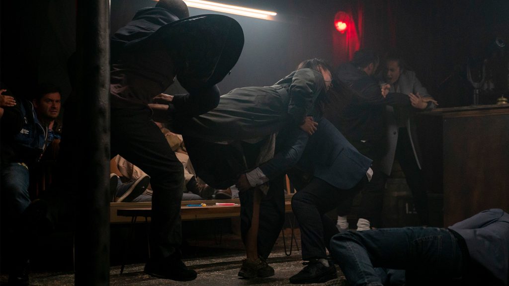 a woman fighting a group of people
