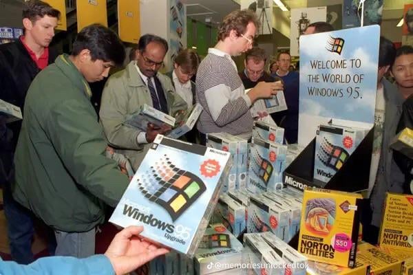 people in a store looking at copies of windows 95