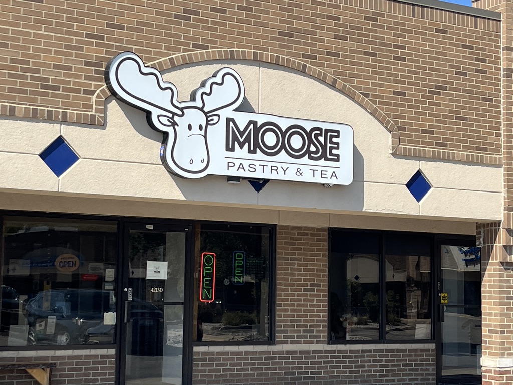 a photo of a bakery in Novi, Michigan called Moose Pastry & Tea. It has a cartoon moose