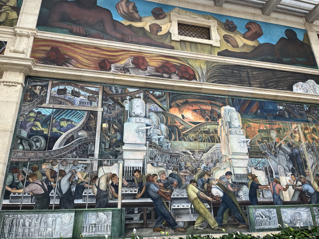 mural of auto workers in an assembly line