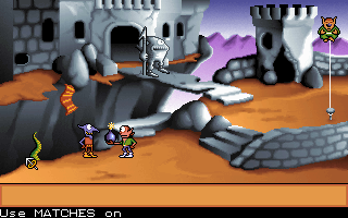 two goblins outside a castle. One is holding a bomb